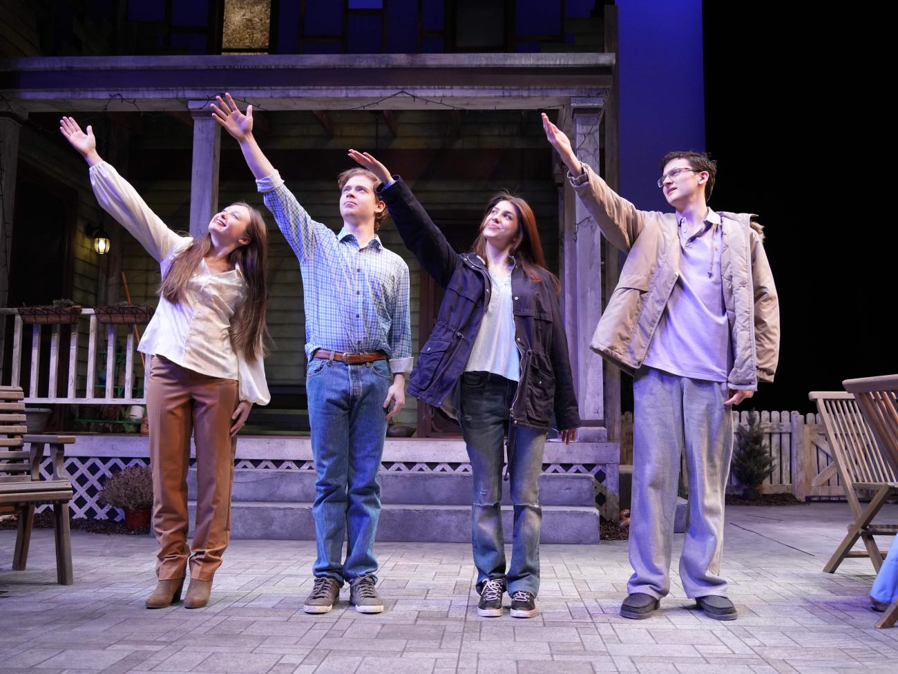 Across standing next to each other looking up with their right arm raised to the sky.