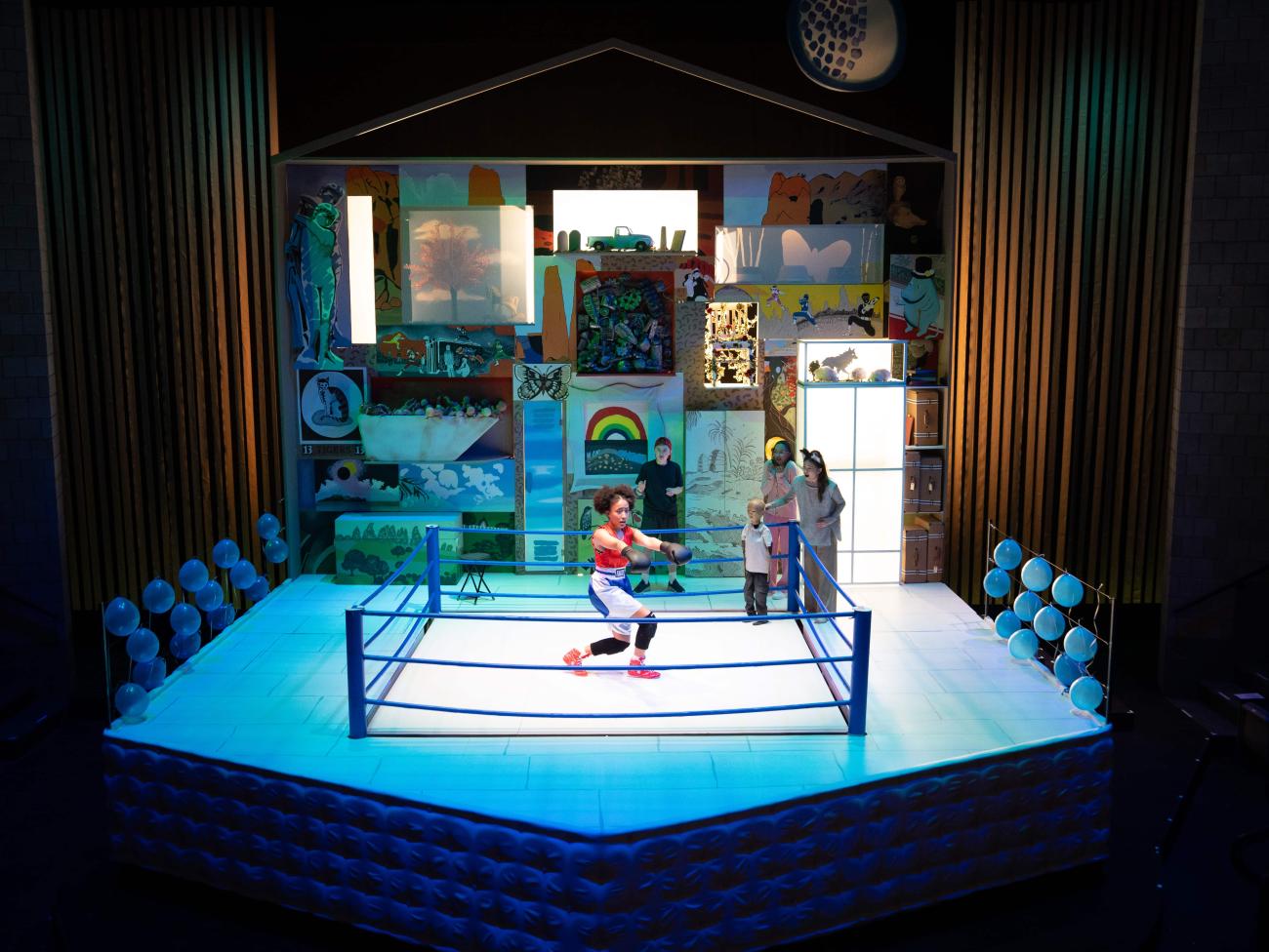 Ash channels strength and determination in the boxing ring as Wolf, Jeenu, Robin, and Ryan watch from the sidelines.