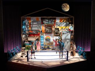 Ryan, Robin, Ash, and Peter stand together in the boxing ring as Jeenu and Wolf watch from the sidelines.