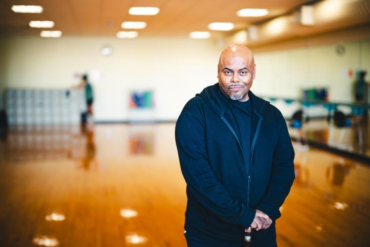 Samuel Reyes in wearing a blue jumpsuit in a dance studio.