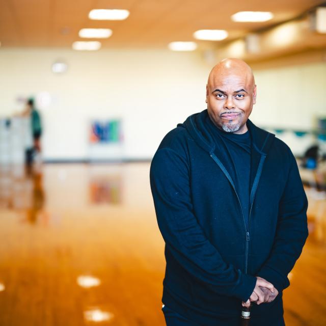 Samuel Reyes in wearing a blue jumpsuit in a dance studio.