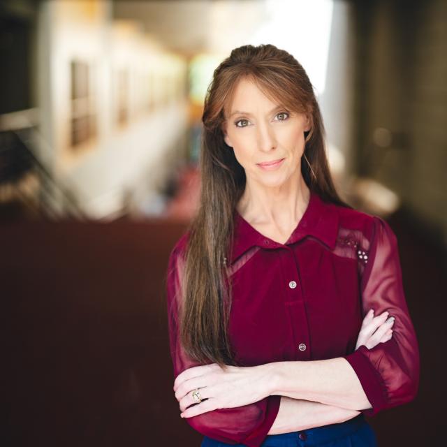 Deb Laub standing for her portrait in Zoellner Arts Center.