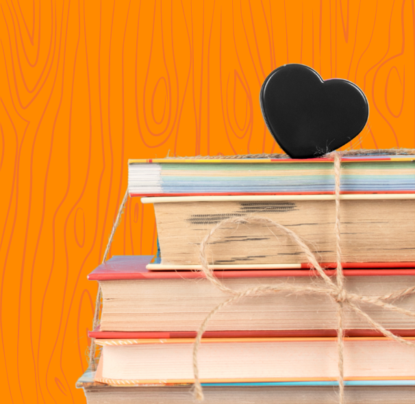 Stacked books with a black heart on top and an orange background.