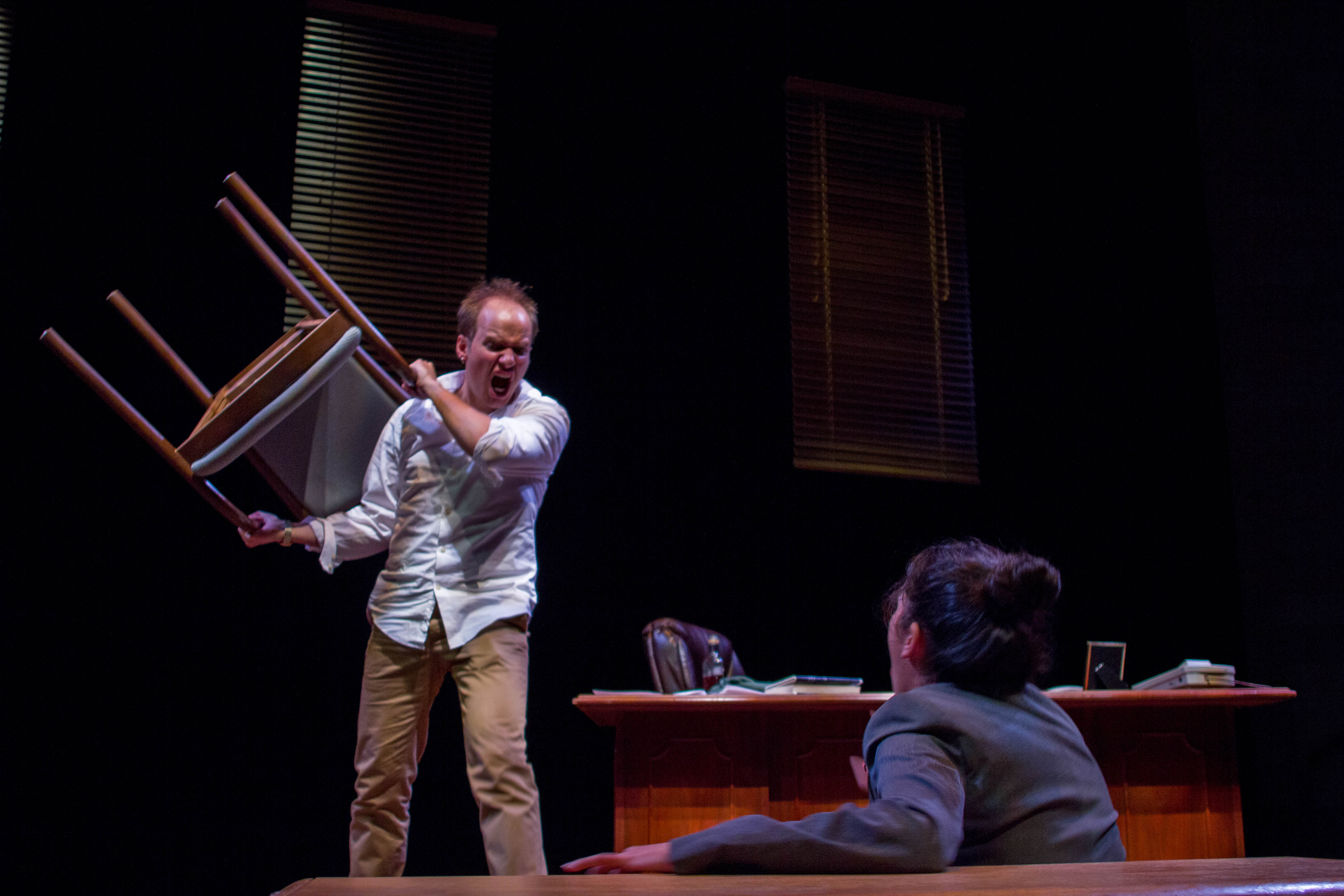 Lehigh University Theatre - Man angrily holding up chair