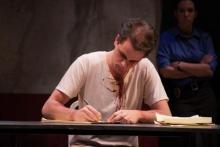 Lehigh University Theatre - The Pillowman, man writing on paper