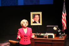 Lehigh University Theatre - Dusty and the Big Bad World, woman in pink in front of desk